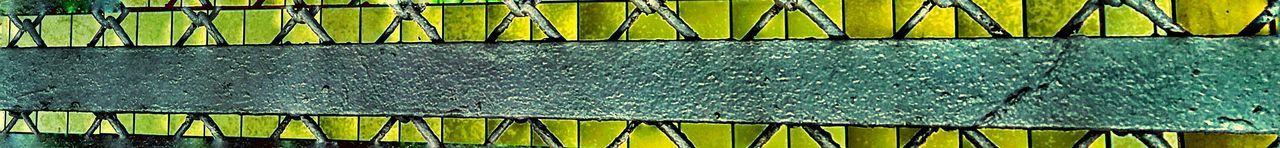 Close-up of yellow metal hanging outdoors