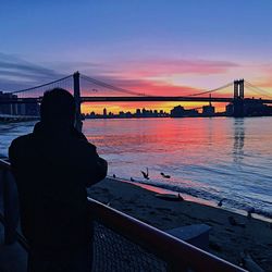 Silhouette man on beach against sky