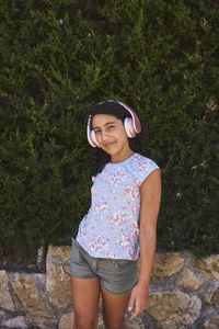 A little girl listening to music with headphones. girl concept