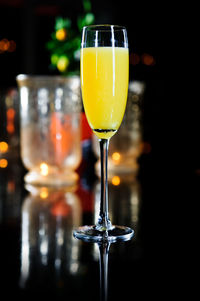 Close-up of yellow drink in glass on table