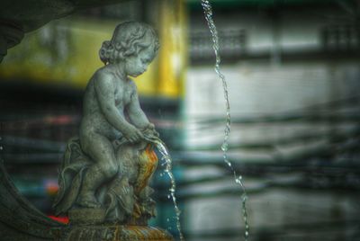 Close-up of statue against water