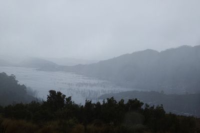 Scenic view of mountains against sky during foggy weather