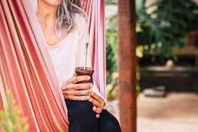 Midsection of a woman drinking glass