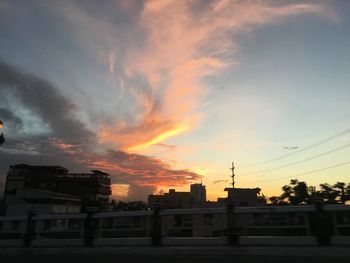 Low angle view of buildings against sky during sunset