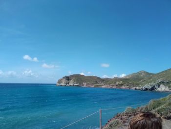 Scenic view of sea against blue sky