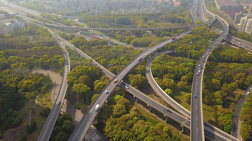 High angle view of highway amidst trees in city