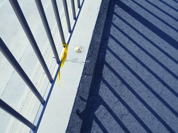 High angle view of metal railing against shadow