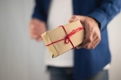 Close-up of human hand holding paper