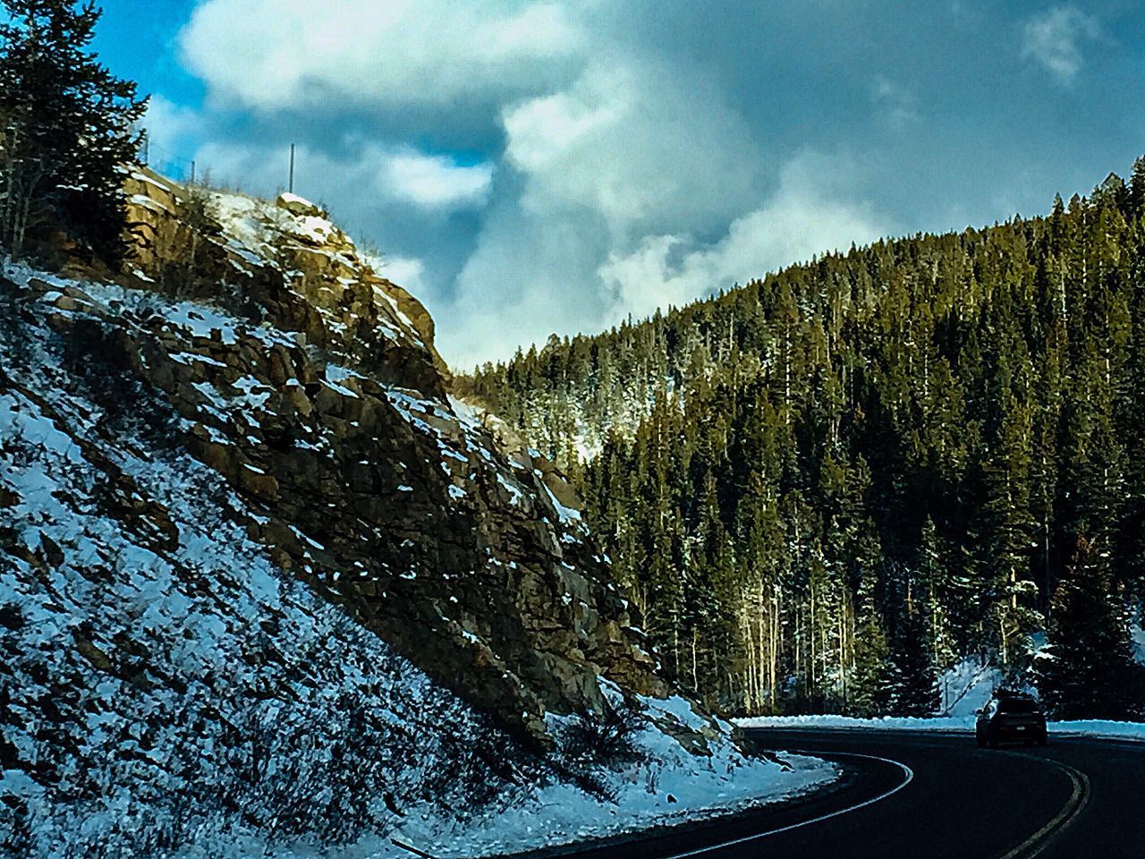 ROAD AMIDST TREES AGAINST SKY DURING WINTER