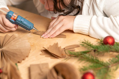 Midsection of woman holding thermometer