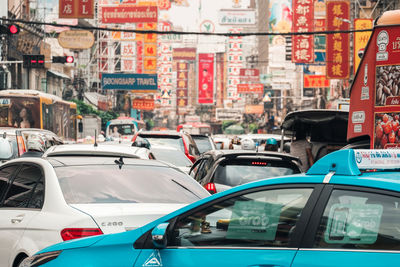 Vehicles on road against buildings in city