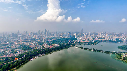 Aerial view of buildings in city against sky