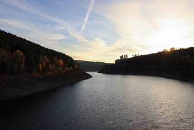 Scenic view of river against sky at sunset