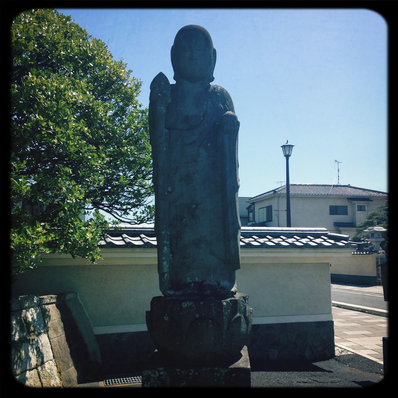 transfer print, auto post production filter, built structure, architecture, building exterior, clear sky, tree, sky, city, sunlight, statue, day, low angle view, outdoors, sculpture, transportation, car, no people, street light, human representation