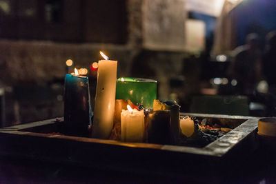 Close-up of lit candles against blurred background