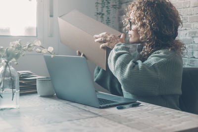 Young woman using laptop at office