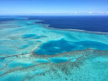 Aerial view of sea against blue sky