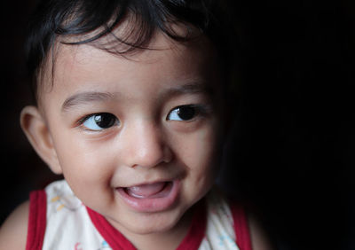 Close-up portrait of cute girl smiling