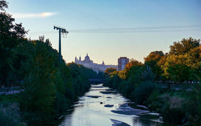 Canal amidst buildings against sky