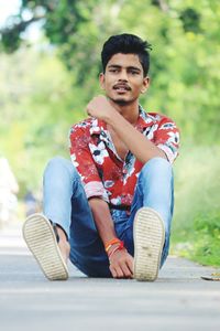 Portrait of young man sitting outdoors