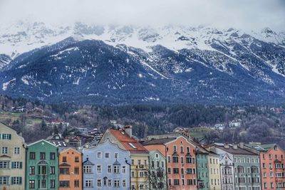 High angle view of houses and snowcapped mountains against sky