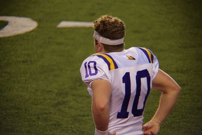 Rear view of person standing on field