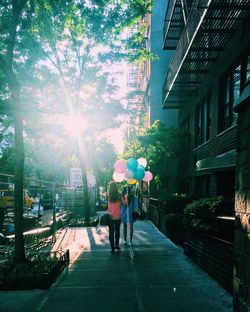 People walking on footpath in city