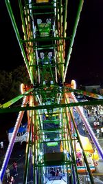 Low angle view of illuminated ferris wheel at night