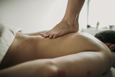 Massage therapist uses the ashiatsu technique to treat her patient