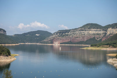 Scenic view of lake and mountains against sky