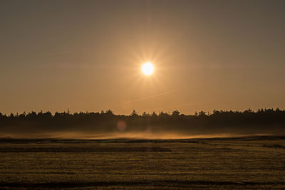 Scenic view of field against sky during sunset