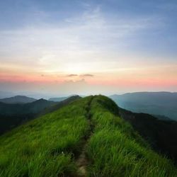 Scenic view of mountains against sky at sunset