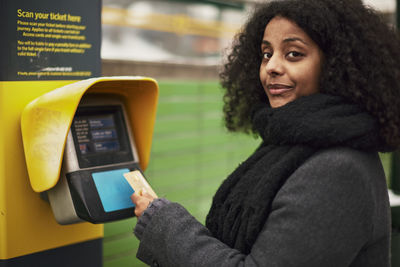 Woman paying for ticket with credit card