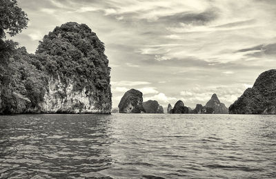 Scenic view of rocks in sea against sky