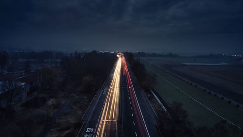 High angle view of light trails on highway at night