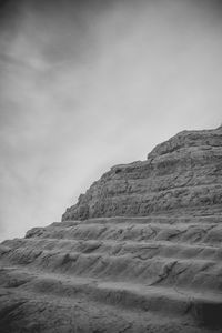 Low angle view of rock formations against sky