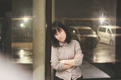Portrait of smiling young woman standing at night