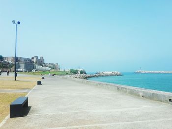 Scenic view of beach against clear blue sky