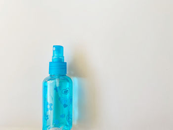 Close-up of blue bottle against white background