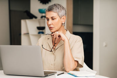 Mid adult woman using mobile phone