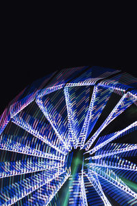 Low angle view of illuminated street lights at night