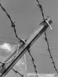 Low angle view of cables against sky