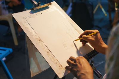 High angle view of person drawing on paper