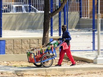 Man riding motorcycle on street in city