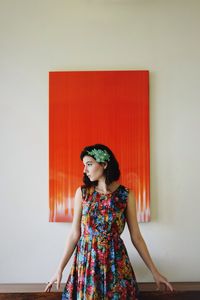 Young woman standing on tiled floor