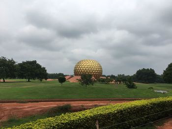 Scenic view of field against cloudy sky