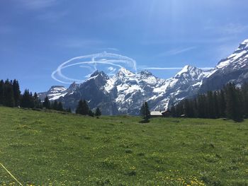 Scenic view of snowcapped field against sky