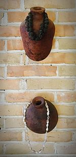 Rusty wheel against brick wall