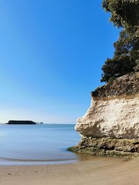 Scenic view of sea against clear blue sky