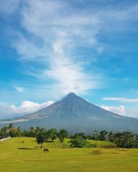 Scenic view of landscape against cloudy sky